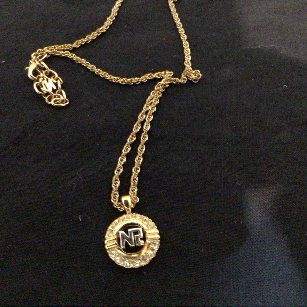 Nina Ricci Signed Gold Plated Necklace with Gold/Silver Logo Pendant/Crystals.